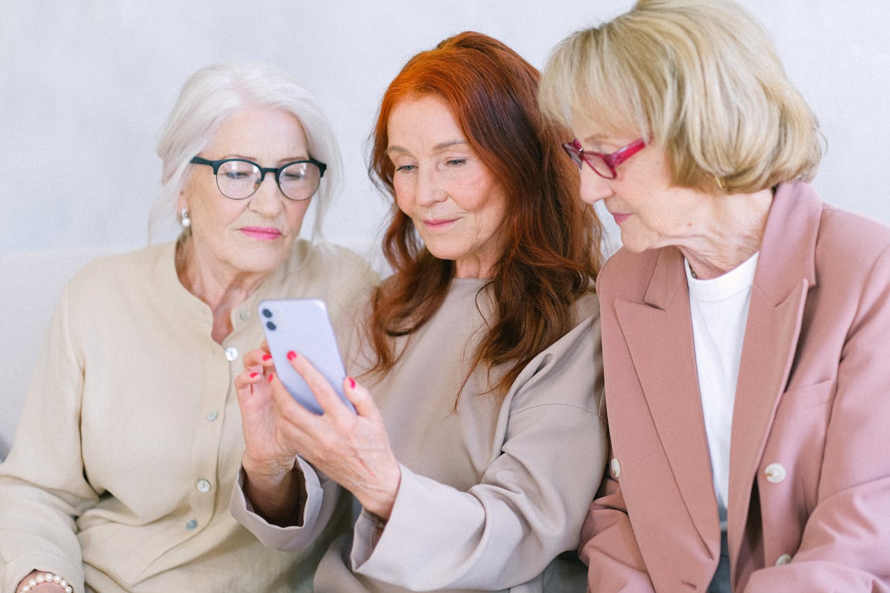 Aged women using smartphone together